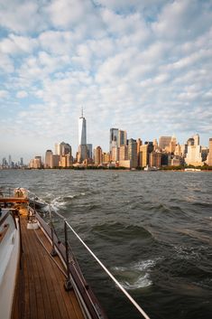 a boat traveling on the water in front of a city