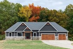 a large house in the middle of a wooded area with lots of trees around it