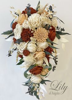 the bridal bouquet is made up of white and brown flowers