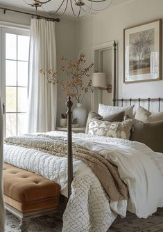 a bedroom with a large bed and a chandelier hanging from it's ceiling