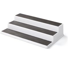 two white and black serving trays sitting on top of each other