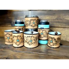 a group of ceramic containers sitting on top of a wooden table