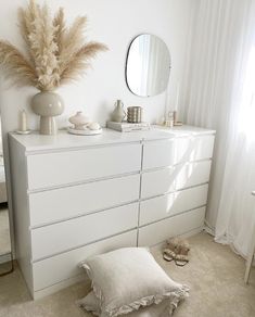 a white dresser and mirror in a room