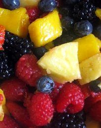 mixed fruit salad with pineapples, raspberries, blueberries and strawberries