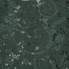 a green background with white and black swirls on the fabric, as well as an abstract design