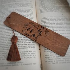 a bookmark with an image of a dog on it and a tassel hanging from the end