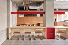 an empty conference room with red and white lighting on the ceiling, along with tables and chairs