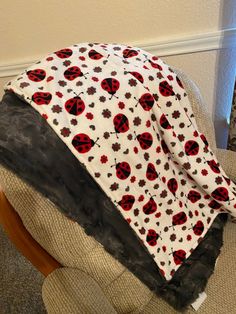 a ladybug blanket sitting on top of a chair