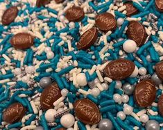 blue and white sprinkles with chocolate candies on them