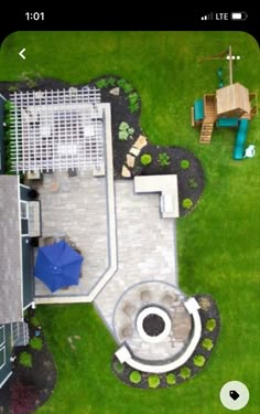 an aerial view of a backyard with a patio, umbrella and picnic table in the background