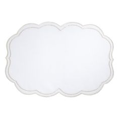 a white place mat with scalloped edges