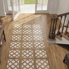 a room with wooden floors and an open door leading to another room that has french doors