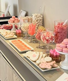 an assortment of desserts and sweets displayed on a buffet table