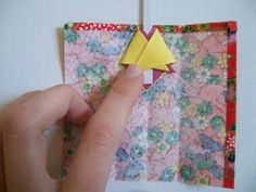 someone is making a paper origami bird