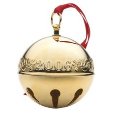 a gold ornament with a red ribbon hanging from it's side on a white background