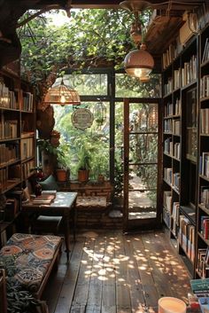 a room filled with lots of books next to a window covered in plants and hanging lights