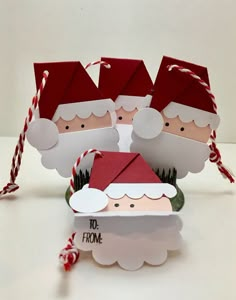 two santa clauss are standing next to each other