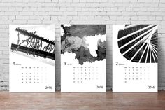 three calendars with black and white designs on them