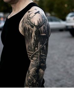 a man with a deer and bear tattoo on his arm