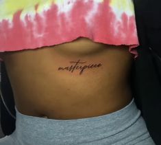 a woman's stomach with the word masterpiece written on it