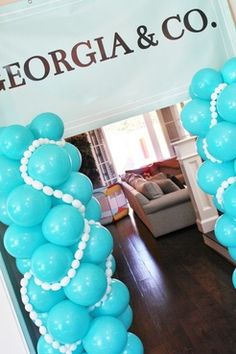 blue balloons are arranged in the shape of an arch for a wedding reception at george & co