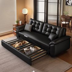 a living room with a black leather couch and coffee table