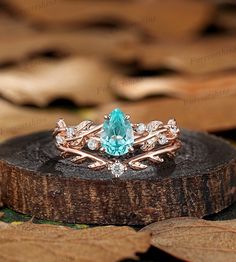 a close up of a ring on top of a tree stump with leaves around it