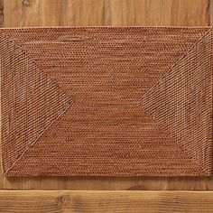 a close up of a brown rug on a wooden floor