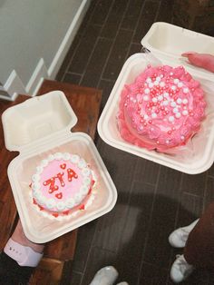 two plastic containers filled with cake on top of a table