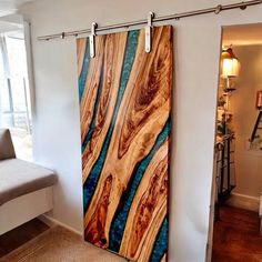 a living room with a couch and sliding glass doors that have woodgrains on them