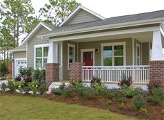 a small house with flowers in the front yard