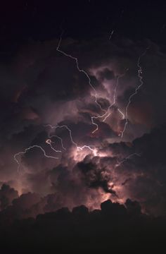 the sky is filled with lightning and clouds