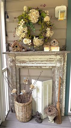 an old fireplace with flowers and wreath on top