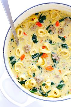 a pot filled with pasta and spinach soup