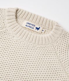 a white sweater with the united alaska label on it