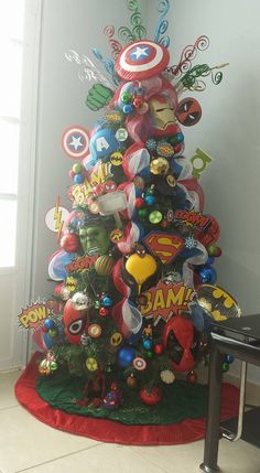 a decorated christmas tree in the corner of a room with an iron man decoration on it