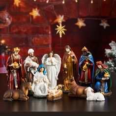 a group of christmas figurines sitting on top of a table