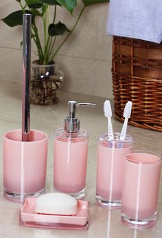 pink bathroom accessories set with soap dispenser and toothbrush holder