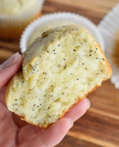 a person holding a muffin in their hand