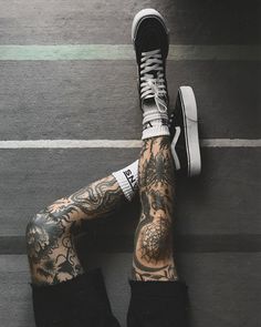 a person with tattoos on their legs and feet