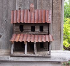 a bird house made out of wood and clay