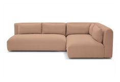 a beige sectional couch with pillows on it's back and the seat facing outward