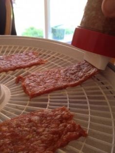 pizza slices are being cut into pieces on a rack