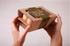 a person holding an open box of eggs