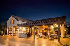 an outdoor living area at night with patio furniture