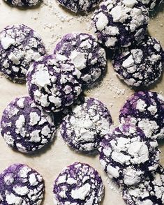 purple and white cookies are on a baking sheet