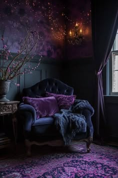 a purple couch sitting in front of a window next to a vase filled with flowers