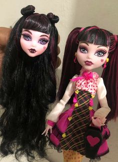 two dolls that are sitting next to each other