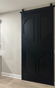 an empty room with a large black door