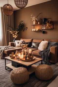 a living room filled with lots of furniture and candles on top of it's coffee table